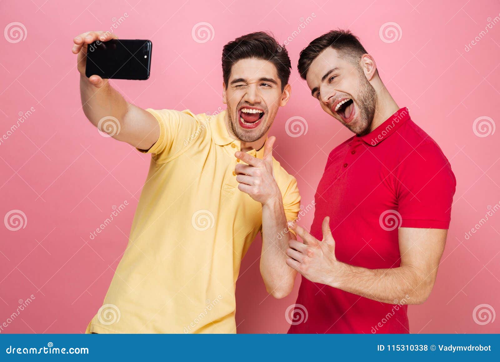 portrait-happy-gay-couple-taking-selfie-mobile-phone-showing-thumbs-up-gesture-isolated-over-pink-background-115310338.jpg