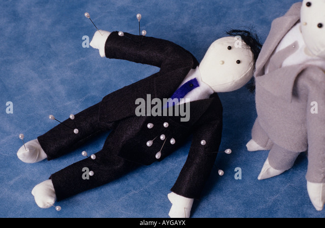 voodoo-doll-lying-down-dressed-as-a-business-man-with-pins-stuck-in-aygayx.jpg