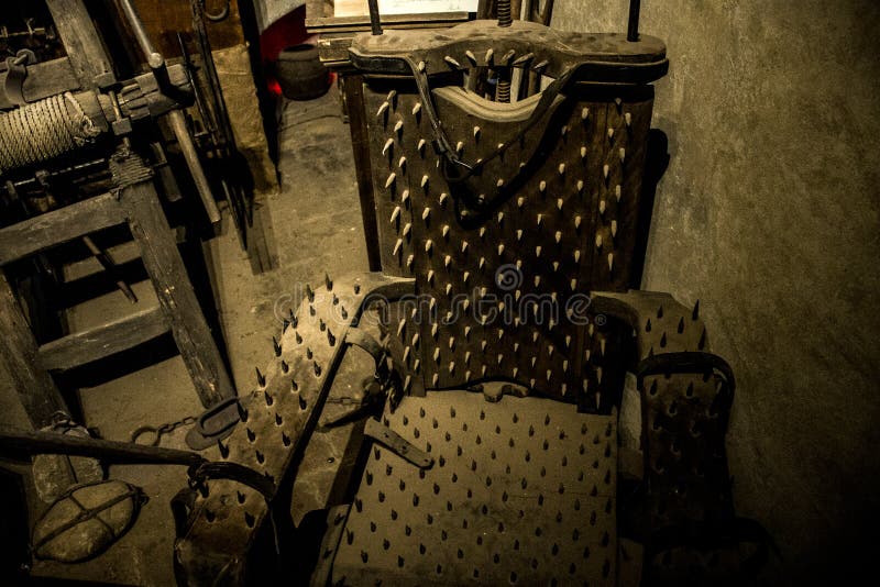 old-medieval-torture-chamber-chair-tools-87999201.jpg